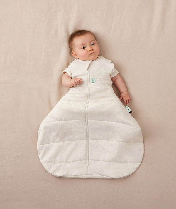 Baby sleeping with arms out in a ergoPouch Hip Harness Cocoon Swaddle Sack 2.5 TOG Oatmeal Marle