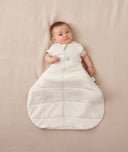 Baby sleeping with arms out in a ergoPouch Hip Harness Cocoon Swaddle Sack 3.5 TOG Oatmeal Marle