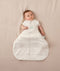Baby sleeping with arms out in a ergoPouch Hip Harness Cocoon Swaddle Sack 3.5 TOG Oatmeal Marle