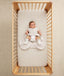 Newborn being dressed in ergoPouch Hip Harness Cocoon Swaddle Sack 3.5 TOG Oatmeal Marle
