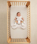 Baby in ergoPouch Hip Harness Cocoon Swaddle Sack 2.5 TOG Oatmeal Marle, with legs open from hip dysplasia