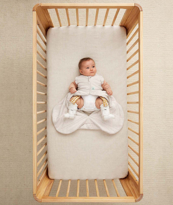 Baby in ergoPouch Hip Harness Cocoon Swaddle Sack 2.5 TOG Oatmeal Marle, with legs open from hip dysplasia