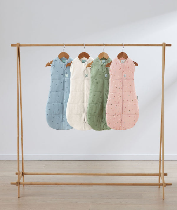 Flatlay of ergoPouch Cocoon Swaddle Sack 3.5 TOG Dragonflies, Daisies, Willow and Oatmeal Marle