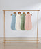 Flatlay of ergoPouch Cocoon Swaddle Sack 3.5 TOG Dragonflies, Daisies, Willow and Oatmeal Marle