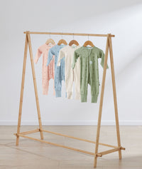 Flatlay of ergoPouch Long Sleeve Romper 1.0 TOG Dragonflies, Daisies, Oatmeal Marle and Willow