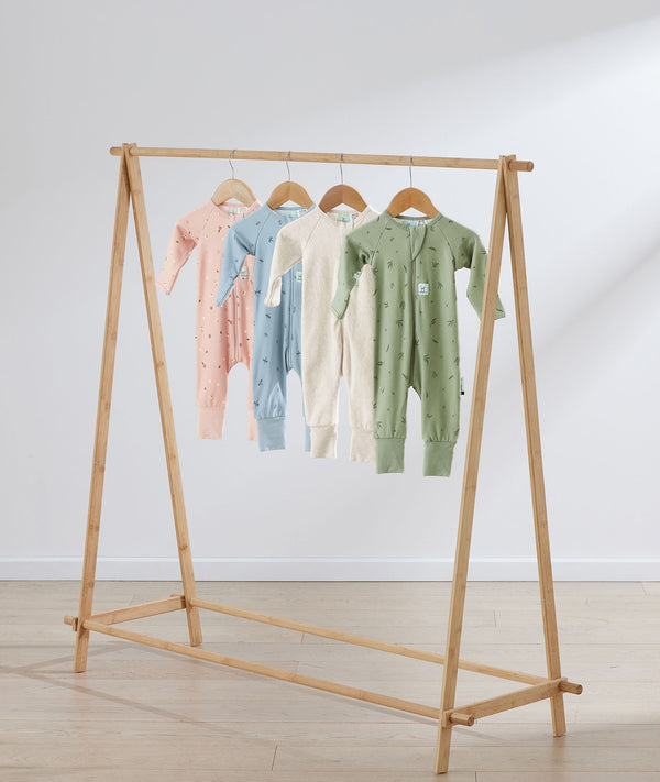 Flatlay of ergoPouch Long Sleeve Romper 1.0 TOG Oatmeal Marle, Dragonflies, Daisies and Willow