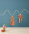 Hanging product shot of ergoPouch Cocoon Swaddle Sack 0.2 TOG and Long Sleeve Romper Sunny