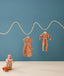 Hanging product shot of ergoPouch Cocoon Swaddle Sack 0.2 TOG and Long Sleeve Romper Sunny