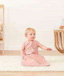 Infant sitting wearing ergoPouch Sleep Sack 1.0 TOG Berries