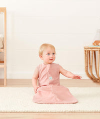 Infant sitting wearing ergoPouch Sleep Sack 1.0 TOG Berries