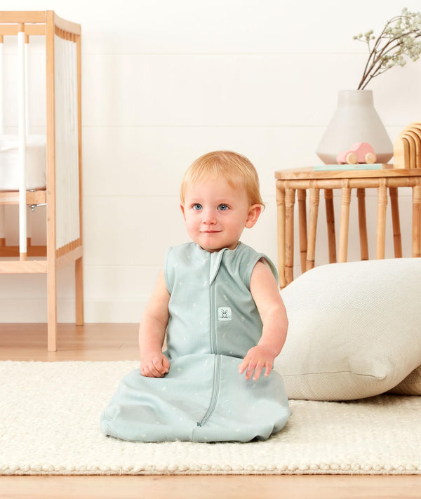 Smiling infant sitting wearing ergoPouch Sleep Sack 0.2 TOG Sage