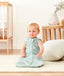 Smiling infant sitting wearing ergoPouch Sleep Sack 0.2 TOG Sage