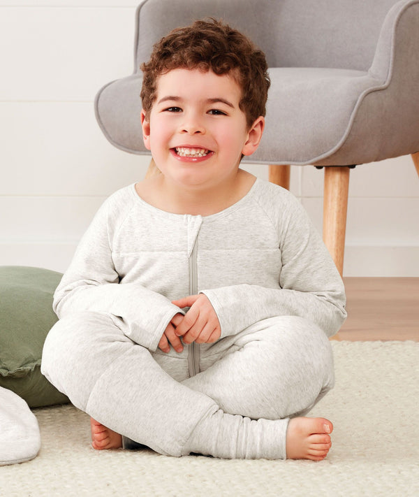 Child sitting in ergoPouch Sleep Onesie 3.5 TOG Grey Marle, warm for the winter