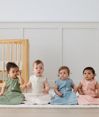 Infants sitting in ergoPouch Sleeping Sack Bon Appetit and Petit Pretzel, perfect for the summer