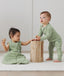 Infants playing wearing ergoPouch Sleep Sack in Willow