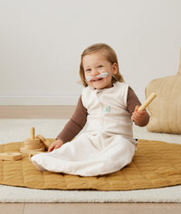 Four infants sitting in ergoPouch Sleeping Sack 1.0 TOG Oatmeal Marle