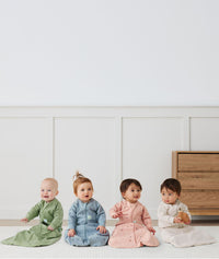 Four babies in ergoPouch Heritage collection Sleep Sacks