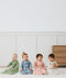 Four infants sitting in ergoPouch Sleep Sack 1.0 TOG Sleeved Daisies, Dragonflies, Willow and Oatmeal Marle