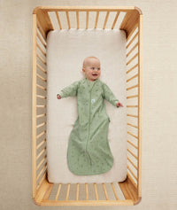 Infant wearing ergoPouch Sleep Sack in Willow