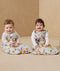 Two babies sitting in ergoPouch Sleep Sack 3.5 TOG Sleeved Fruit Salad