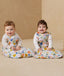 Two babies sitting in ergoPouch Sleep Sack 3.5 TOG Sleeved Fruit Salad