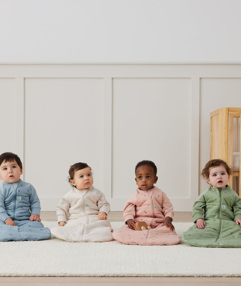 Four babies in ergoPouch Heritage collection Sleep Sacks
