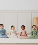 Four infants sitting in ergoPouch Sleep Sack 2.5 TOG Sleeved Daisies, Dragonflies, Willow and Oatmeal Marle