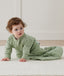 Infant wearing ergoPouch Sleep Sack in Willow