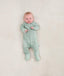 Newborn wearing an ergoPouch Long Sleeve Romper 0.2 TOG Sage