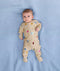 Newborn lying on its back wearing ergoPouch Long Sleeve Romper 0.2 TOG in Birthday Blobs