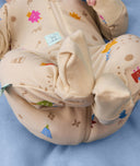 Close shot of a baby's legs and feet in ergoPouch Long Sleeve Romper 0.2 TOG in Birthday Blobs