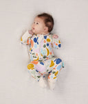 Baby lying in ergoPouch Long Sleeve Romper 1.0 TOG Fruit Salad