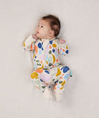 Baby lying in ergoPouch Long Sleeve Romper 1.0 TOG Fruit Salad