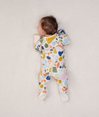 Baby lying in ergoPouch Long Sleeve Romper 1.0 TOG Fruit Salad