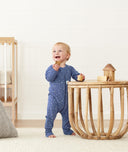 Infant standing wearing ergoPouch Long Sleeve Romper 0.2 TOG Night Sky