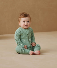 Infant sitting, wearing an ergoPouch Long Sleeve Romper 1.0 TOG Sweet Orchard