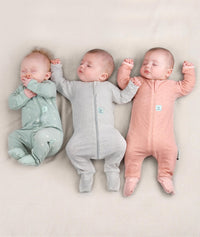 Three babies asleep in Baby wearing ergoPouch Long Sleeve Romper in Sage, Grey Marle and Berries