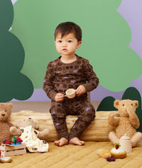 Toddler sitting, wearing an ergoPouch Long Sleeve Pajamas 1.0 TOG Picnic