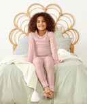 Preschooler sitting, wearing ergoPouch Long Sleeve Pajamas 1.0 TOG Berries