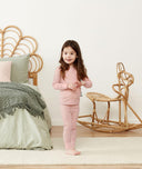 Toddler standing in a comfy long-sleeve-pajamas-1-0-tog-berries