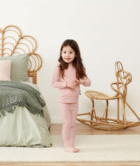 Toddler standing in a comfy long-sleeve-pajamas-1-0-tog-berries