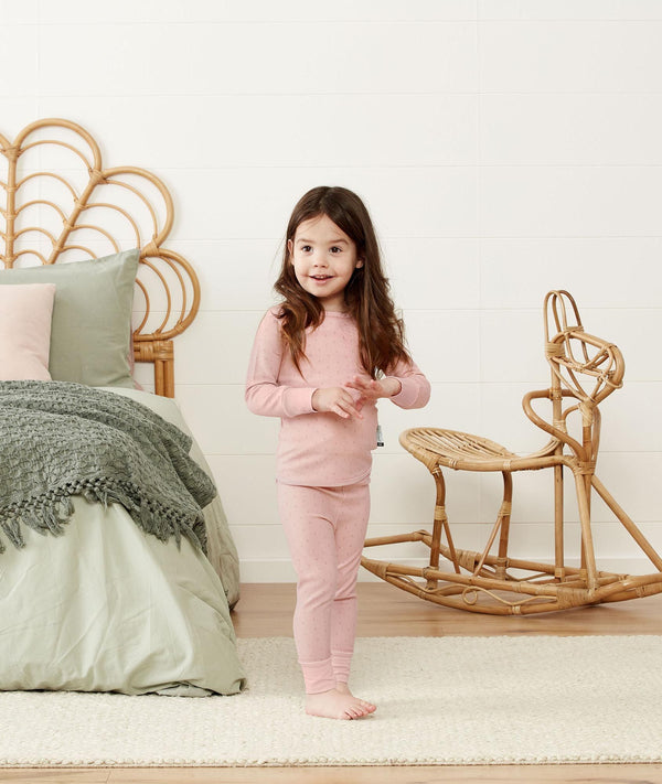 Toddler standing in a comfy long-sleeve-pajamas-1-0-tog-berries