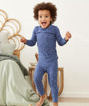 Happy child wearing ergoPouch Pajamas 1.0 TOG Night Sky