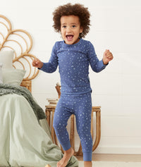 Happy child wearing ergoPouch Pajamas 1.0 TOG Night Sky
