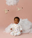 Infant sitting in ergoPouch Long Sleeve Romper 1.0 TOG Daydream