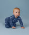 Baby crawling in ergoPouch Long Sleeve Romper 1.0 TOG Starbeam
