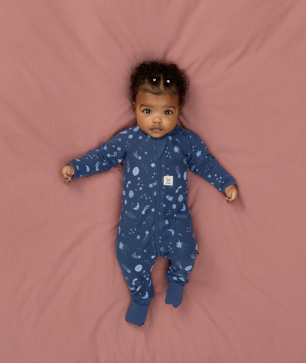 Baby lying in an ergoPouch Long Sleeve Romper 1.0 TOG Daydream with the fold-over cuffs