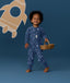 Toddler smiling in an ergoPouch Long Sleeve Romper 1.0 TOG Daydream whilst holding a basket