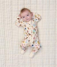 Baby lying on it's back wearing ergoPouch Long Sleeve Romper 1.0 TOG in Bon Appetit
