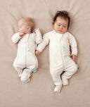 Two newborns lying wearing ergoPouch Long Sleeve Romper 1.0 TOG Oatmeal Marle